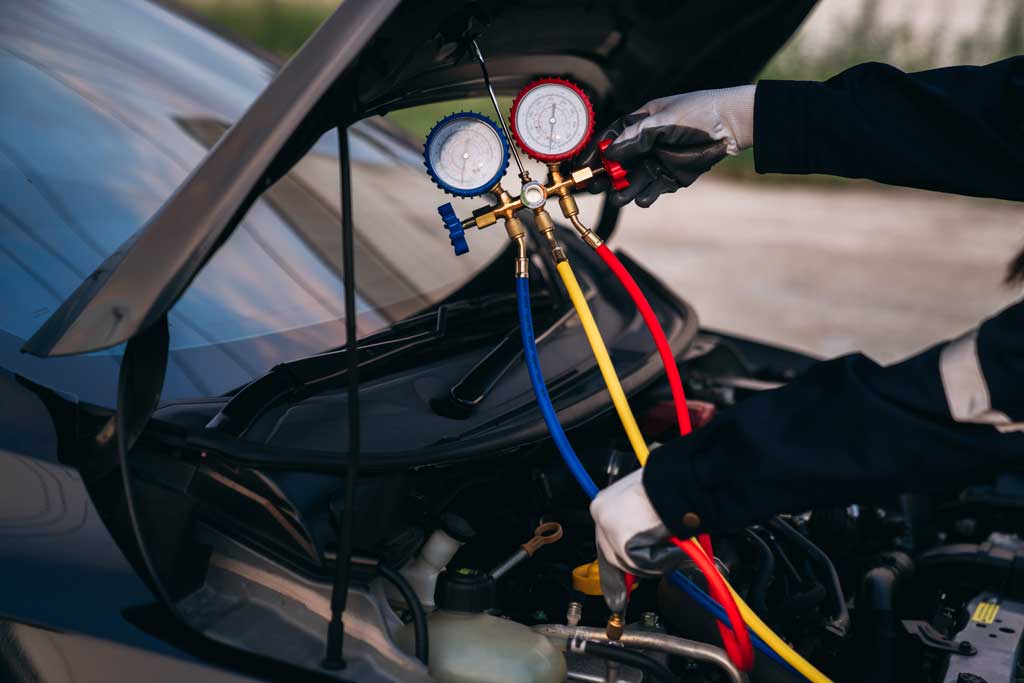 A person inspecting the engine compartment of a car, ensuring everything is in proper working condition.